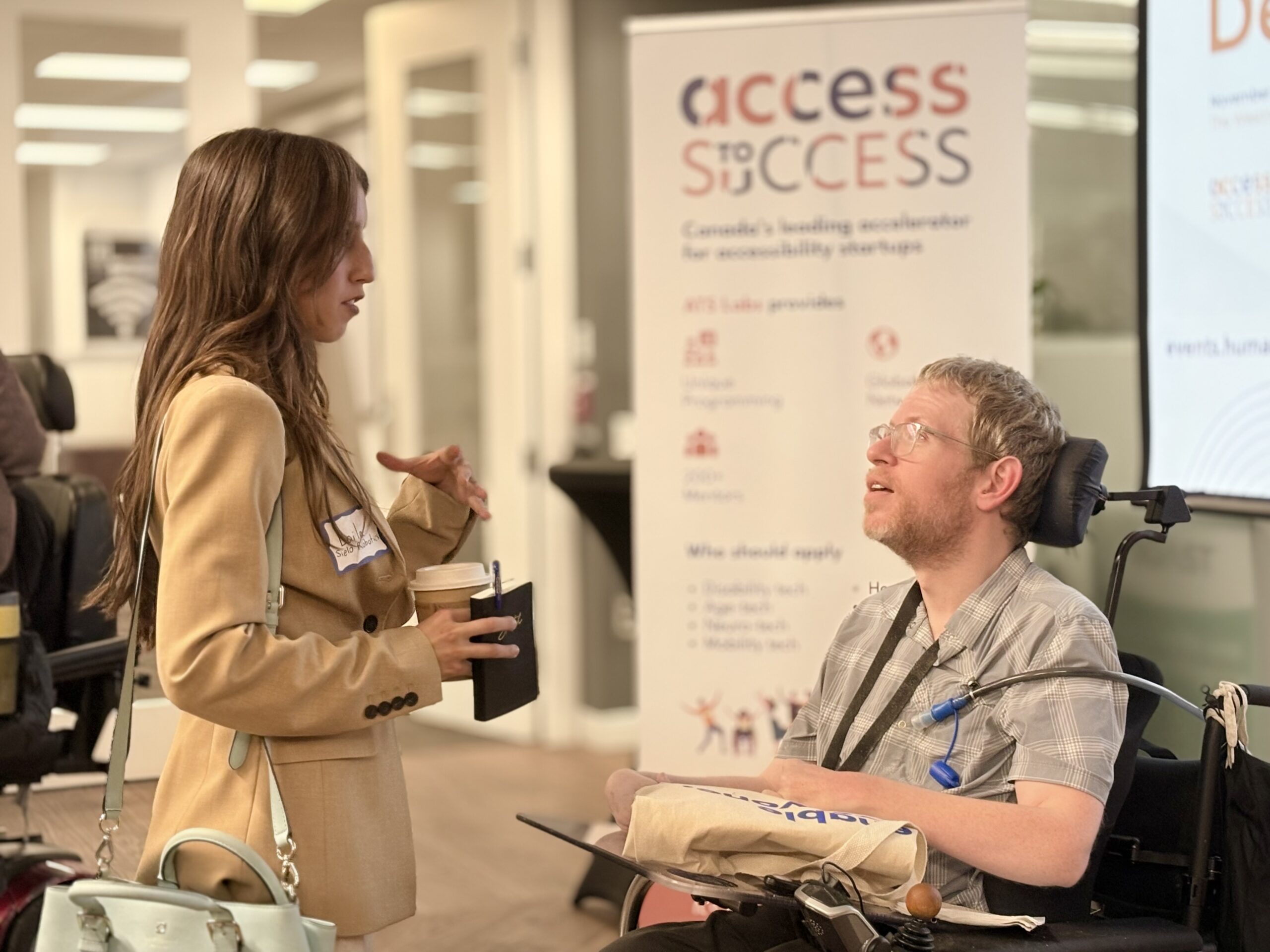 A young woman and a young man in a wheelchair speaking about Access to Success
