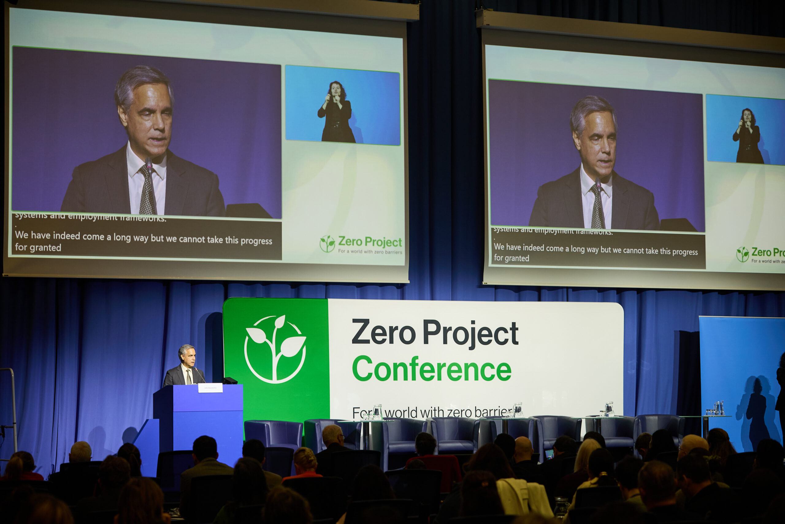 A man at a podium speaking at the Zero Project Conference