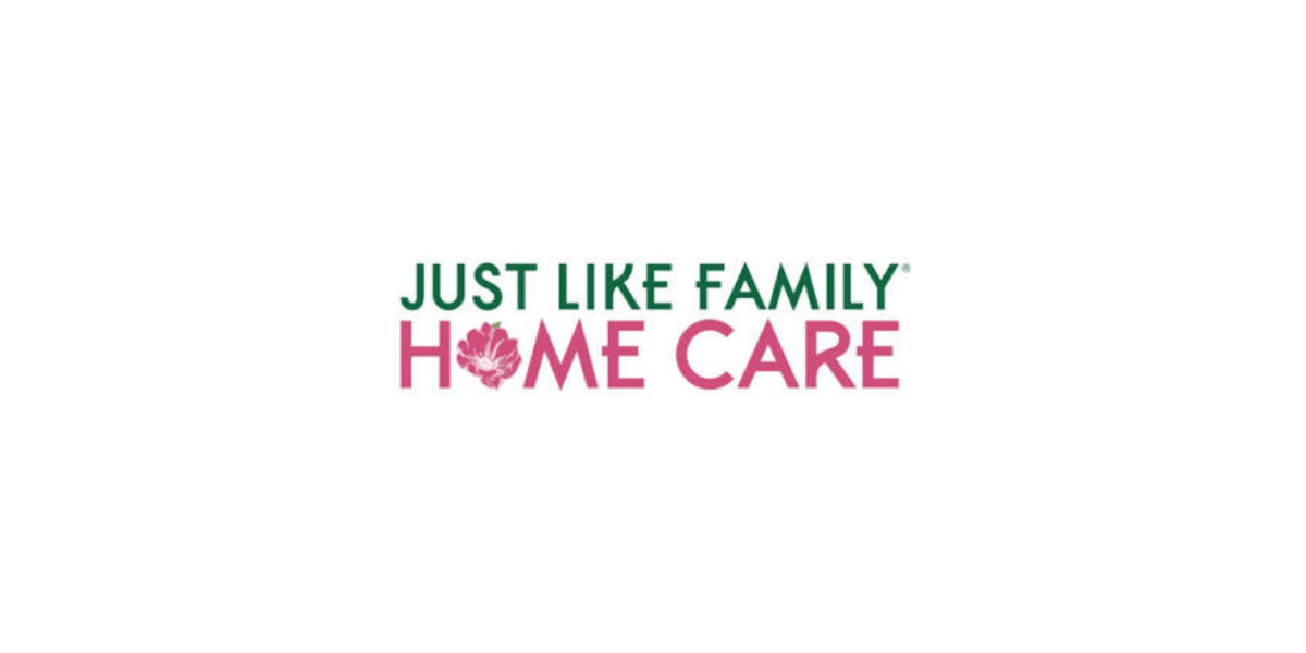 Just Like Family Home Care logo with green and pink text and a pink flower replacing the "O" in "HOME" on a white background.